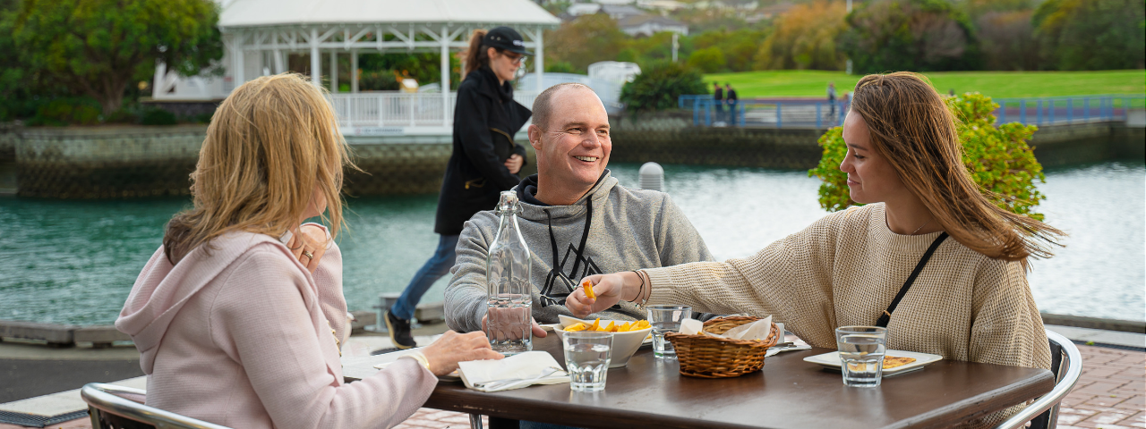 Brad and his family enjoying some food at a local cafe in Gulf Harbour