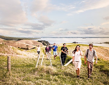 A group of people walking on Auckland's Motutapu Island