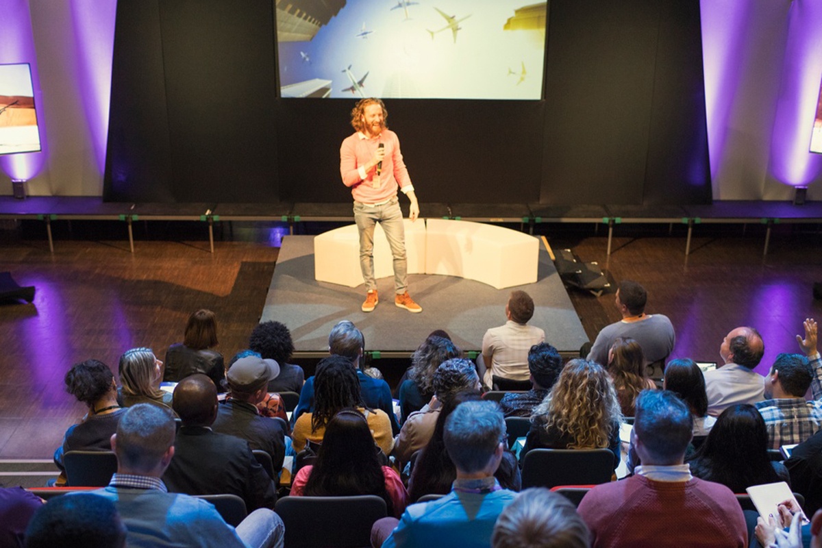 Presenter on stage at a conference