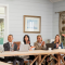 Delegates in a boardroom clapping