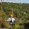 two people riding a EcoZip zipliner a tourism adventure in Auckland