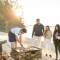 Delegates watching a chef cook on the beach