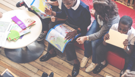 overhead shot of children sitting around learning