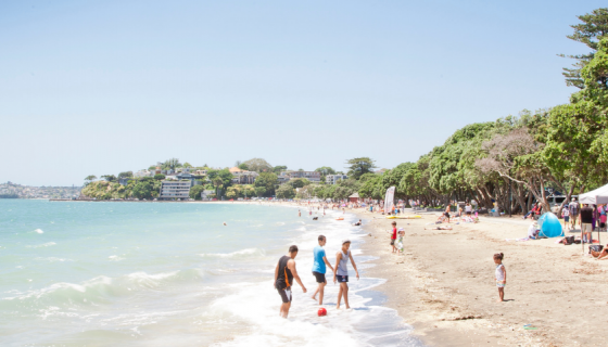 Beach scene of people playing in the water on a summers day
