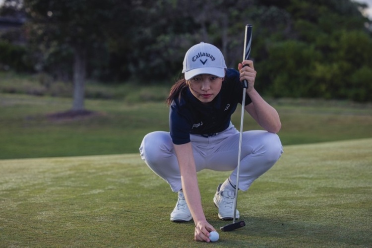 A woman playing golf